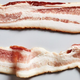 Two strips of uncured bacon